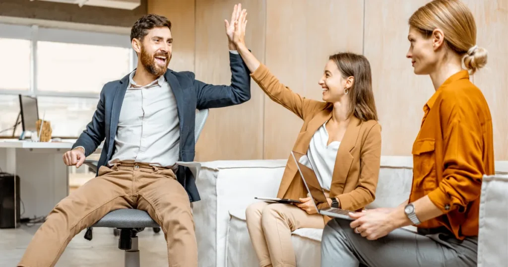 Illustration of happy employees staying with a company because of a positive work environment, career growth, and supportive leadership